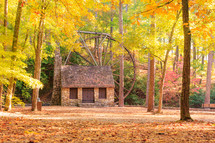 Stone building with water wheel in the fall