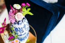 pink flowers in a blue and white porcelain vase 
