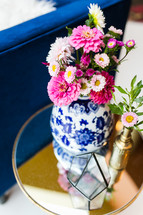pink flowers in a blue and white vase 