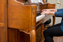 a woman playing a piano 