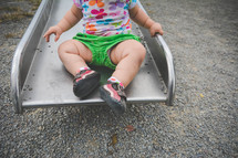a toddler on a slide 