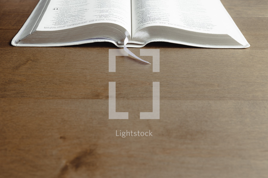 open Bible on a wood background with copy space 