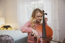 teen girl playing a cello