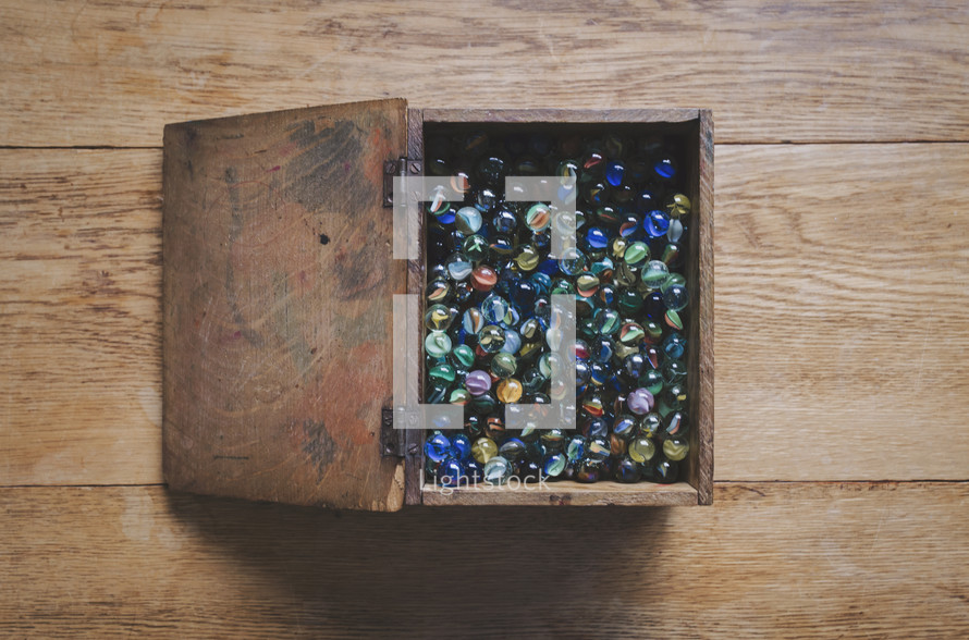 an open box of marbles, a nostalgic children's toy