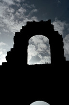 silhouette of and arch at arena el jem in tunisia