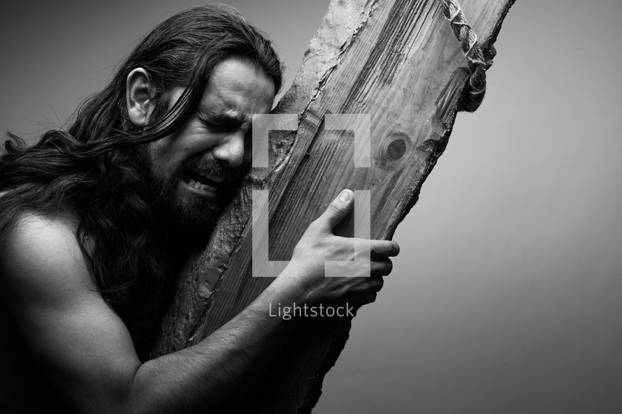 The suffering of Christ -- Jesus crying in pain while carrying the cross.