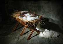 manger with a crown of thorns laying in it