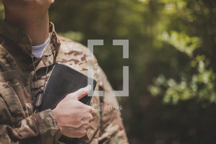 serviceman holding a Bible