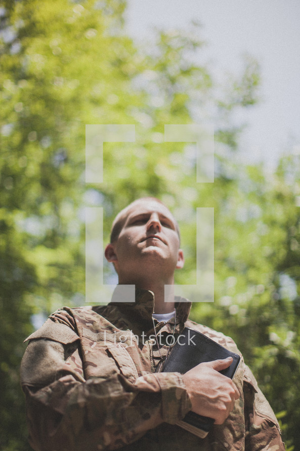 serviceman holding a Bible over his heart