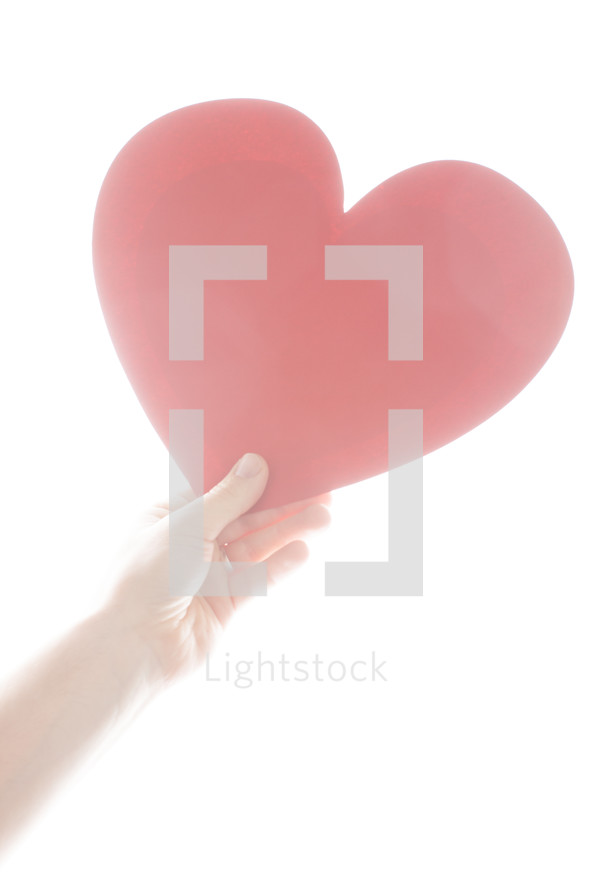 arm holding a large red paper heart 