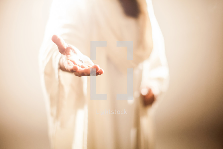 Jesus extending His hand as an invitation to follow Him.