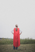 A super hero mom dressed in a red cape