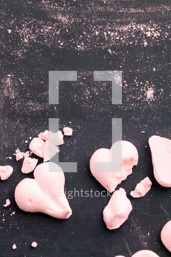 crumbs and pink heart shaped cookies 