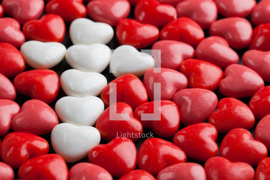 cross shape in heart shaped red and white candy