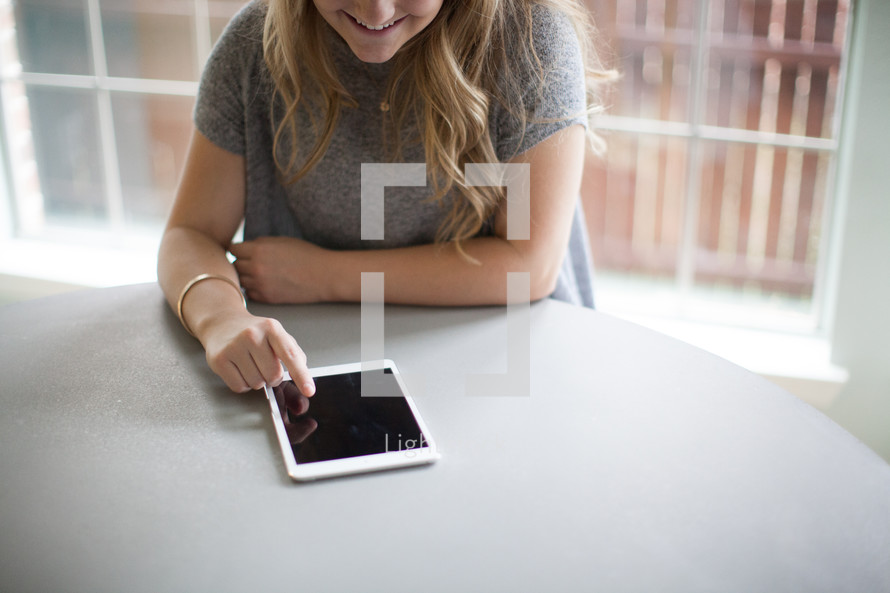 woman looking at an iPad screen 
