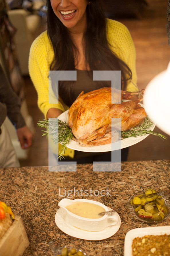 woman holding a Thanksgiving Turkey 