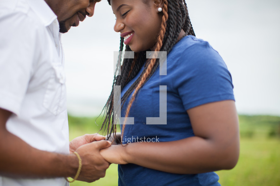 happy African-American couple holding hands outdoors 