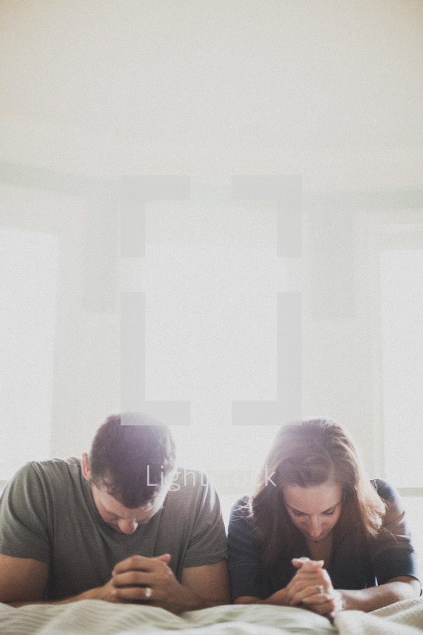 husband and wife in prayer 