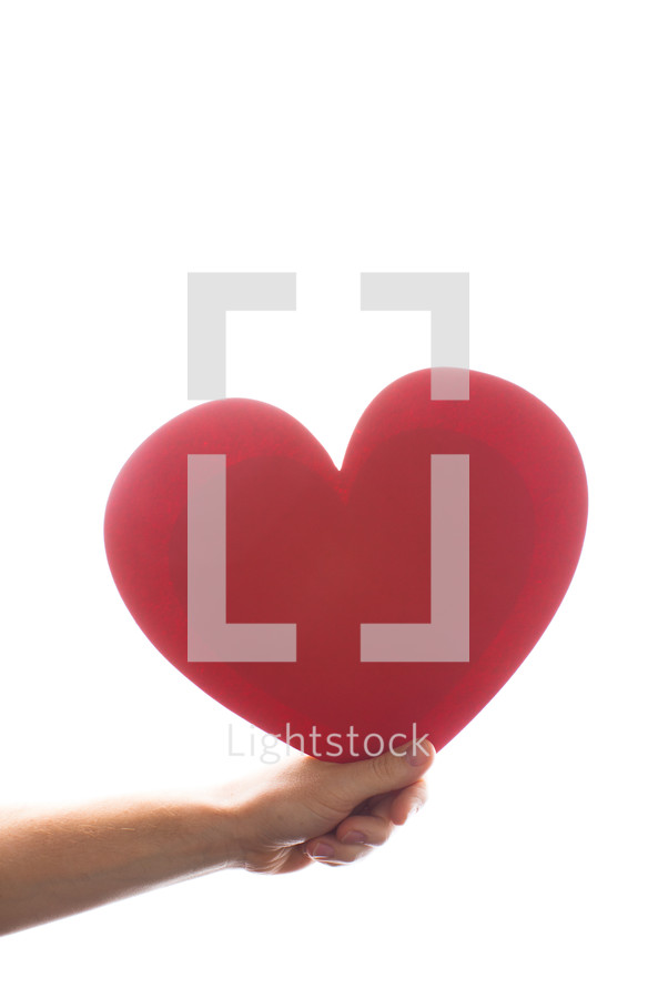 hand holding a large red heart 