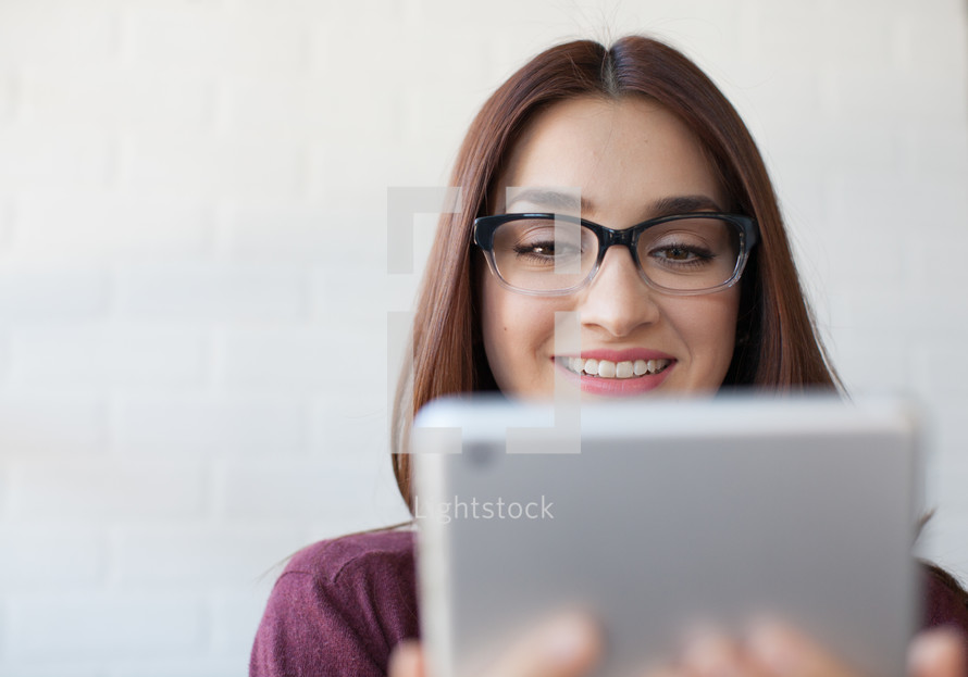 latino woman looking at her iPad screen 