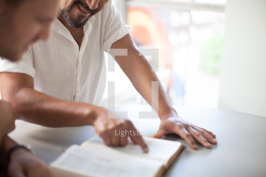 two men reading a Bible 