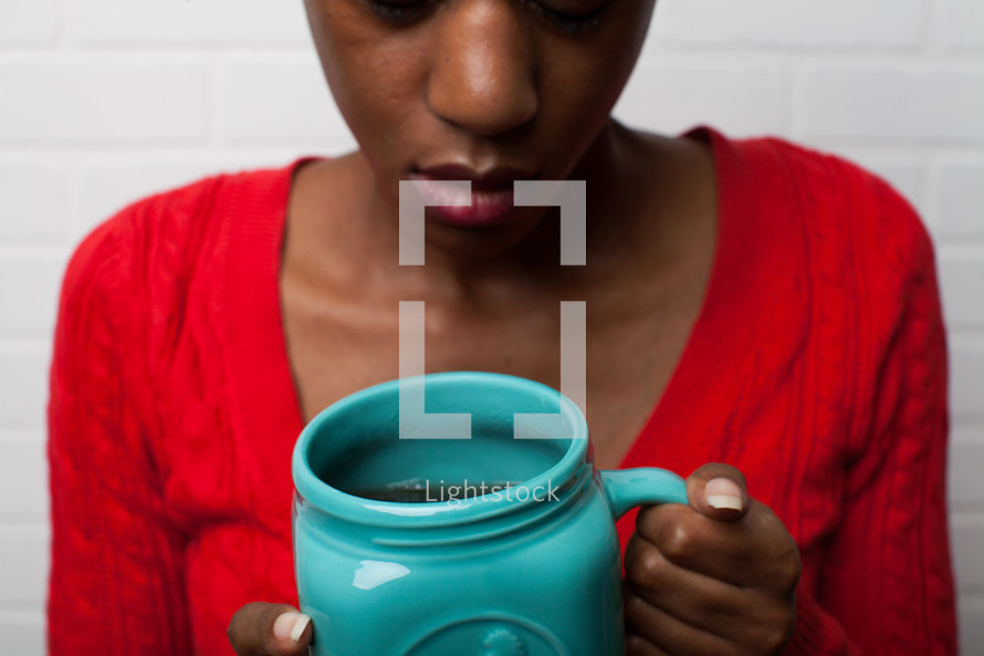 African-American woman holding a mug  