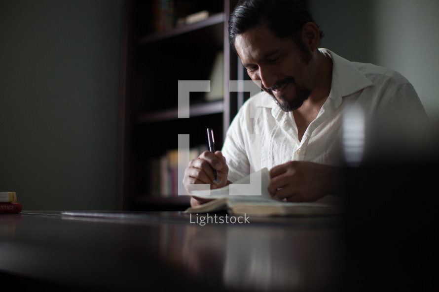 A man studying a Bible.