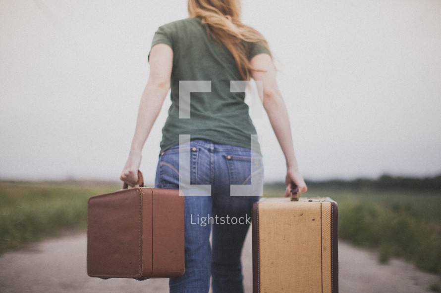 woman carrying suitcases