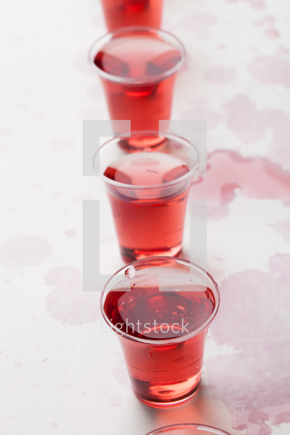 red wine in communion cups 