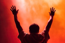 A Man Worshiping with Hands Raised