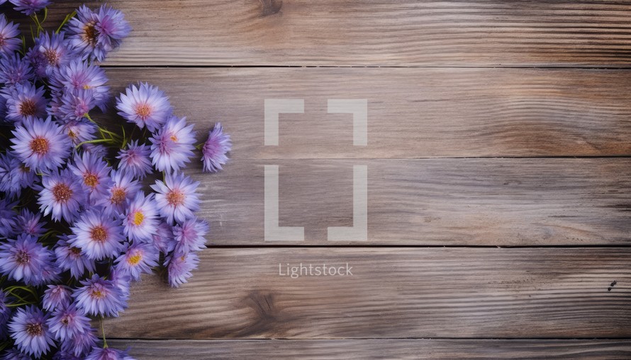 Bouquet of purple flowers on wooden background. Top view.
