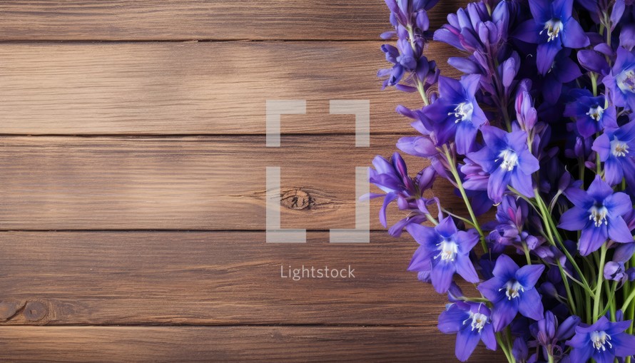 Bluebells on wooden background. Top view with copy space.