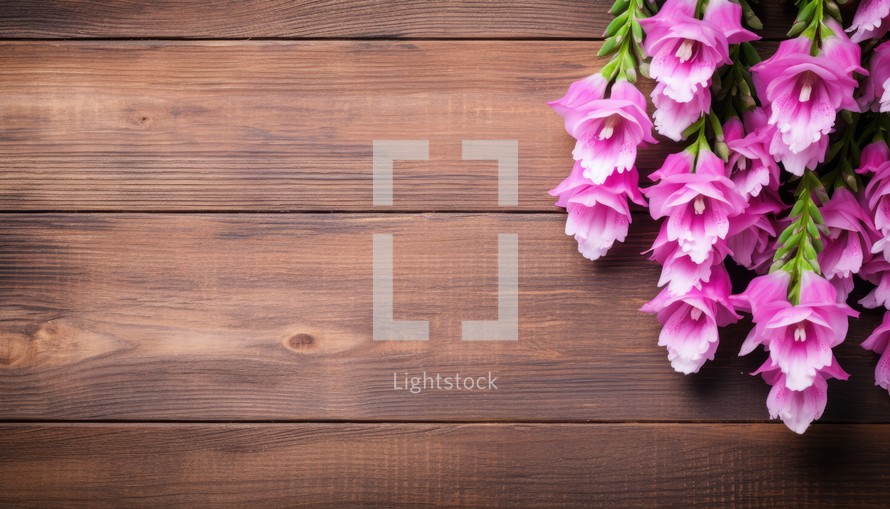 bouquet of pink freesia flowers on wooden background with copy space