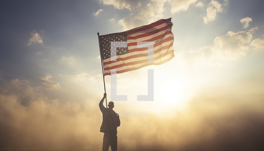 Businessman holding american flag against blue sky over clouds with sun