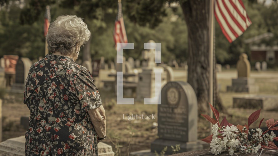 Elderly woman in a Graveyard with flags