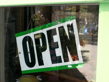 OPEN sign hanging in the window of a small business