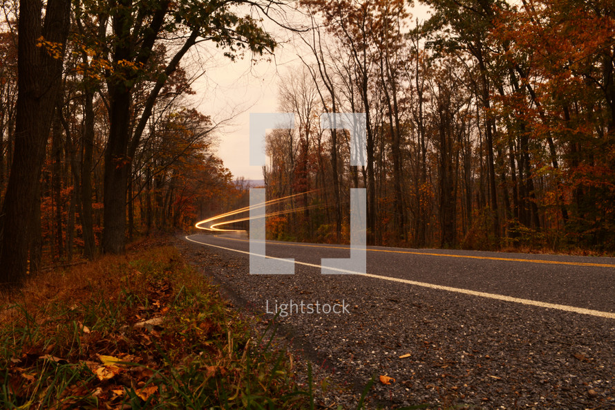 streaks from headlights on an autumn highway 
