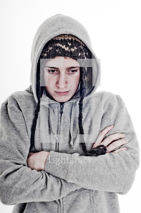 man with his arms folded in a toboggan and sweatshirt 