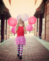 a little girl with balloons 