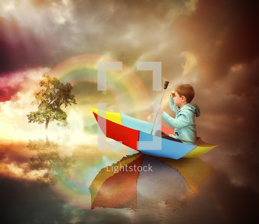 a child floating in a rainbow colored umbrella 