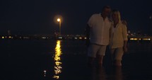 Couple watching candles sailing on water