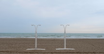 Showers on the beach with ocean waves in background