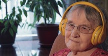 Senior Woman Listening to the Music in Headphones