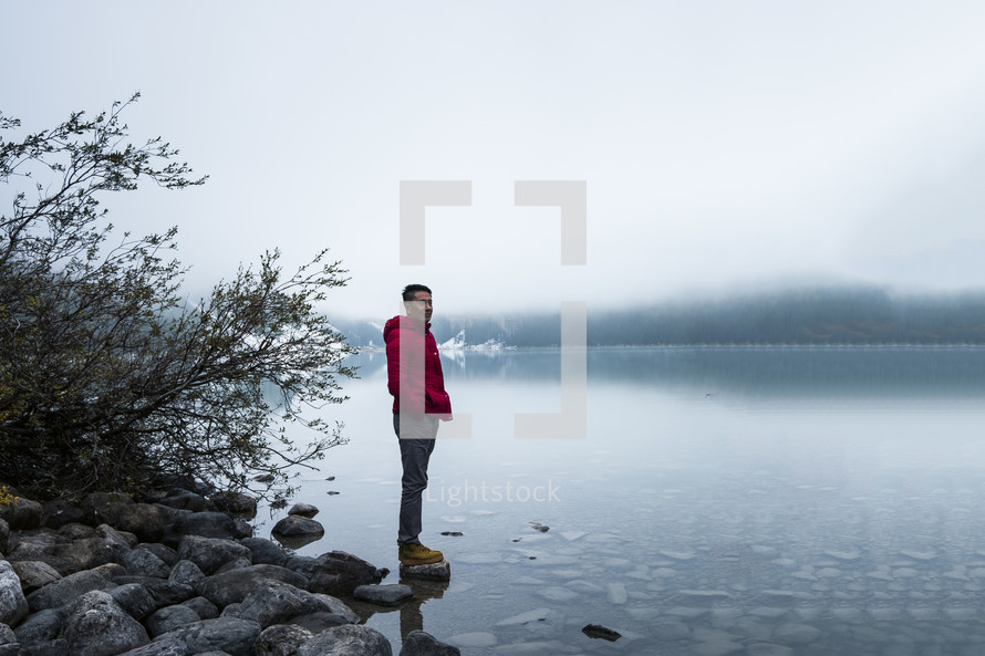man standing on the shore of Lake Louise 