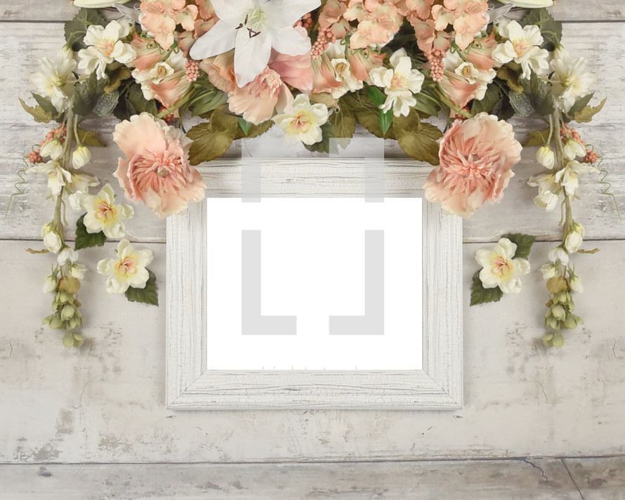 old frame surrounded by flowers 