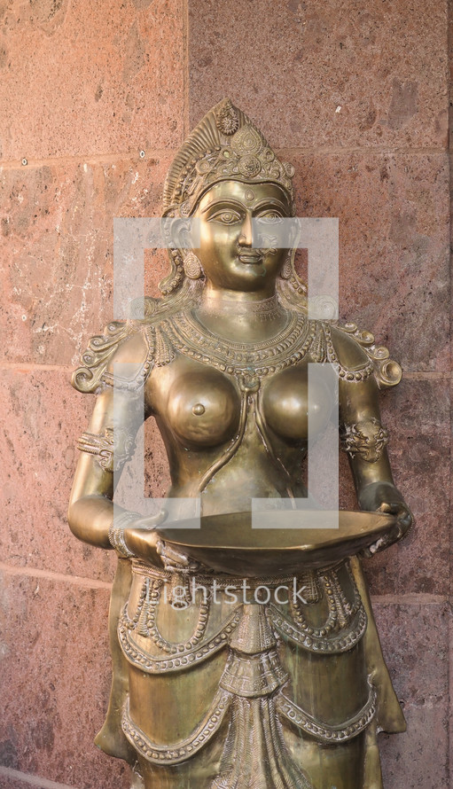 ancient golden statue of traditional indian goddess