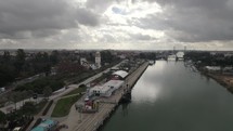 Seville Cruise Terminal on cloudy day, Spain. Scenic aerial forward 