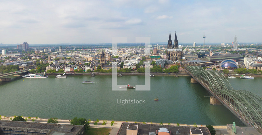 KOELN, GERMANY - CIRCA AUGUST 2019: Aerial view of the city seen from river Rhein (Rhine). From Left To Right, The Altstadt (Old Town), Rathaus (Town Hall), Dom (Cathedral) And Hohenzollern Bridge