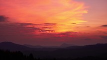 Pastel colors of the sky at sunset in a hilly rural landscape