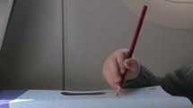 Close up view of small boy learning to writing with pencil